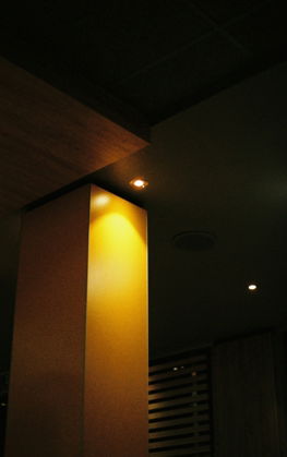 A tall pillar illuminated by warm light.
